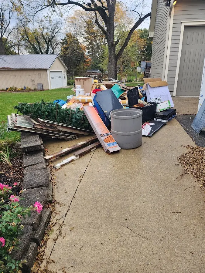 Dumpster being loaded with debris for Estate Cleanout Dumpster Rental in Timberlake